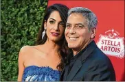  ?? JORDAN STRAUSS / INVISION 2017 ?? George Clooney’s production company is teaming up on a docuseries based on SI executive editor and senior writer Jon Wertheim’s cover story that brought the Ohio State sex abuse scandal to a national audience last October. Pictured with Clooney is wife Amal.