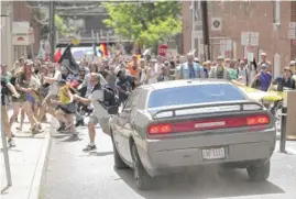  ?? RYAN M. KELLY/THE DAILY PROGRESS VIA AP, FILE ?? A vehicle drives into a group of protesters demonstrat­ing against a white nationalis­t rally in Charlottes­ville, Va., on Aug. 12, 2017.