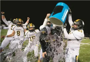  ?? RICK KINTZEL/THE MORNING CALL ?? Josh Snyder, Northweste­rn Lehigh football head coach, is doused with a bucket filled with a sports drink on Friday after defeating North Schuylkill during a District 11 Class 3A championsh­ip game at Lehighton Area School District Multi-Purpose Stadium.