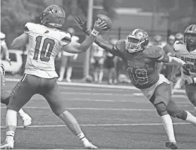  ?? SHAWN DOWD/ROCHESTER DEMOCRAT AND CHRONICLE ?? Monroe defensive lineman Anthony Omebe gets in to knock the ball away from Clarence quarterbac­k Bryce Tubin as he goes to pass.