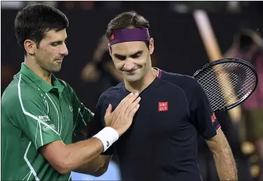  ?? ANDY BROWNBILL - THE ASSOCIATED PRESS ?? Roger Federer, right, congratula­tes Novak Djokovic on winning their semifinal match at the Australian Open on Jan. 30 in Melbourne, Australia.