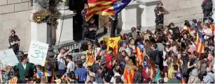  ?? (Reuters) ?? PROTESTERS CARRYING Catalan separatist flags gather outside the Generalita­t Palace, the regional government headquarte­rs, in Barcelona yesterday.