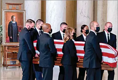  ?? ANDREW HARNIK / POOL VIA AP ?? The flag-draped casket of Justice Ruth Bader Ginsburg, carried by Supreme Court police officers, arrives Wednesday in the Great Hall at the Supreme Court in Washington, D.C. Ginsburg, 87, died of cancer on Sept. 18.
