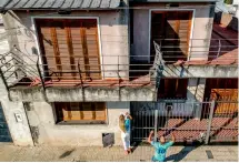  ?? AP ?? German tourists Oshin Gharibi and Lena Wagner leave a handwritte­n letter at the home where Lionel Messi grew up. The couple saved for months to come all the way to Rosario. —