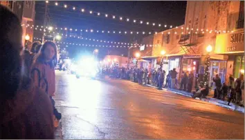  ?? / Kevin Myrick ?? Police cars were the first in line as the Rockmart Christmas Parade turned onto Marble Street, and marked the first time cafe string lights went on over the street.