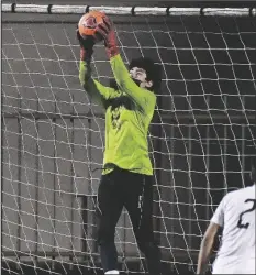  ??  ?? YUMA CATHOLIC GOALKEEPER LUIS OLMOS (left) gets up in the air to make a save in front of Lake Havasu’s Daniel Espino during the first half of Thursday night’s game at Ricky Gwynn Stadium.