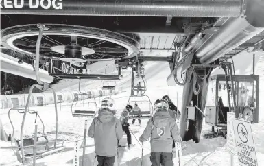  ?? CAYCE CLIFFORD/THE NEWYORKTIM­ES ?? Skiers board the Red Dog chairlift Dec. 12 at Squaw Valley Ski Resort in Olympic Valley, California. The resort felt“so dead,”said skier Sabrina Nottingham. The coronaviru­s pandemic also hit ski resorts in the spring.