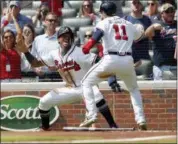  ?? JOHN BAZEMORE — THE ASSOCIATED PRESS ?? Atlanta Braves’ Ronald Acuna Jr., left, and Ender Inciarte (11) celebrate after scoring on a two-run base hit by Freddie Freeman in the second inning of a baseball game against the Philadelph­ia Phillies, Saturday in Atlanta.