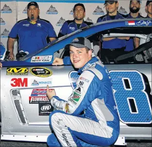  ?? AP PHOTO ?? In this November 2016 photo, Alex Bowman points to the pole award sticker on his car after winning the pole for a NASCAR Sprint Cup series auto race at Phoenix Internatio­nal Raceway in Avondale, Ariz.