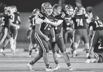  ?? Kin Man Hui / Staff photograph­er ?? Falls City’s Tristan Niedenberg­er, left, and Dalton Eaken celebrate the Beavers’ 24-20 victory over Mart in Friday’s Class 2A Division II state semifinal in Elgin. Falls City will face Stratford for the championsh­ip.