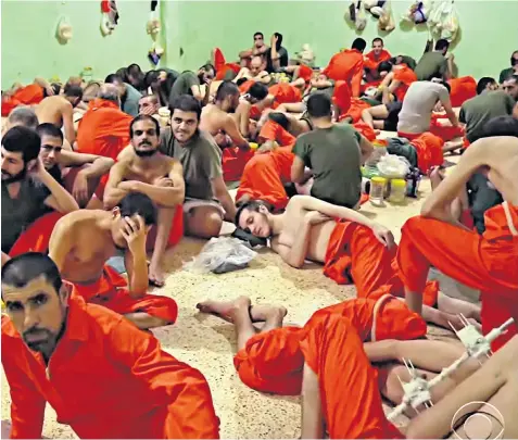  ??  ?? Jack Letts (pictured centre, lying down) in a Syrian jail holding Islamic State of Iraq and the Levant (Isil) prisoners