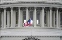  ?? PATRICK SEMANSKY — THE ASSOCIATED PRESS ?? An American flag flies at half-staff above the Capitol Building in Washington on Friday in remembranc­e of U.S. Capitol Police Officer Brian Sicknick. Sicknick died from injuries sustained as President Donald Trump’s supporters stormed the Capitol.