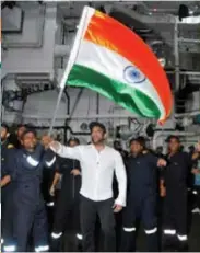  ?? ?? Salman Khan waves the flag with Indian Naval sailors on the INS Visakhapat­nam.