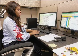  ?? ISMAIL TURAY JR./STAFF ?? Coria Richardson, a senior in environmen­tal engineerin­g at Central State University, enters water and sewer data at the Montgomery County Environmen­tal Services building in Kettering on Feb. 13. Richardson’s internship is a result of a partnershi­p between the county and CSU that calls for the university to conduct research and provide interns to work with Environmen­tal Services.