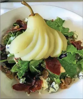  ?? PHOTO COURTESY OF STEPHANIE CARNEY ?? Blue Pear Bistro’s signature salad features pear, crispy prosciutto, blue cheese and more.