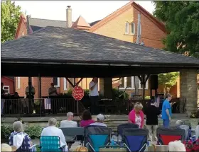  ?? PHOTO COURTESY OF MADISON VILLAGE ?? Spectators enjoy a musical performanc­e at Madison Village Concerts in the Park in 2018.