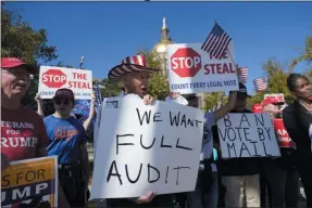  ?? JOHN BAZEMORE ?? Supporters of President Donald Trump hold signs during a rally outside the Georgia State Capitol Friday, Nov. 13, 2020, in Atlanta.