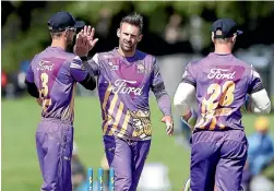  ?? PHOTO: GETTY IMAGES ?? Andy Ellis takes an Otago Volts wicket and celebrates with Chad Bowes in T20 at Alexandra’s Molyneux Park yesterday.