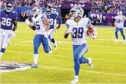  ?? BILL KOSTROUN/ASSOCIATED PRESS ?? Detroit’s Jamal Agnew (39) returns a punt for a touchdown during the Lions’ win over the New York Giants Monday night.