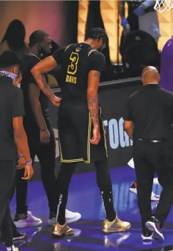  ?? Mike Ehrmann / Getty Images ?? Lakers forward Anthony Davis walks off the court in the first quarter of Game 5 of the Finals. Davis is the leading scorer in these playoffs with 563 points in 20 games.