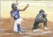  ??  ?? Ringgold sophomore Baileigh Pitts slides home past LaFayette catcher Madi Ashley during the Lady Tigers’ seasonopen­ing 9-4 victory last Monday in LaFayette.