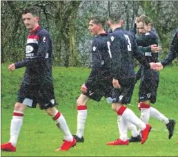  ?? Report and photograph­s: Derek Black ?? Donald Campbell is congratula­ted by his team mates after netting the killer third goal just after the second half had started.