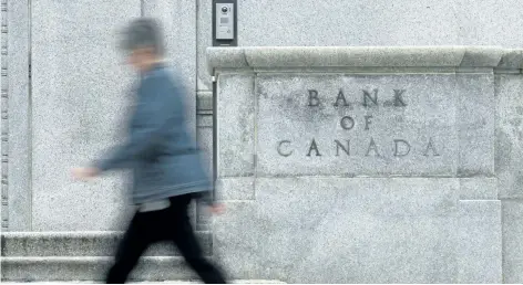  ?? THE CANADIAN PRESS FILES ?? Above: A woman walks past the Bank of Canada. The bank’s deputy governor, Timothy Lane, says the bank is keeping an eye on protection­ist sentiment among some of Canada’s trading partners, particular­ly in regards to the renegotiat­ion of NAFTA.