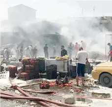  ??  ?? موقع انفجار سيارة ملغومة في سوق بمدينة الصدر أمس. (أ ف ب)