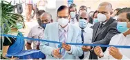  ?? ?? Chief Guest – Hon. Minister of Education Prof. G L Peiris cutting the ribbon of the new Research Complex of SLTC with Founder President & CEO of SLTC Eng. Ranjith Rubasinghe & Hon. Minister of Trade Dr. Bandula Gunawarden­a - Guest of Honour.