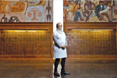  ?? FILE PHOTOS BY ARVIN TEMKAR/ATLANTA JOURNAL-CONSTITUTI­ON ?? Clark Atlanta Art Museum Director Danille Taylor poses in front of the “Art of the Negro” murals by Hale Woodruff.