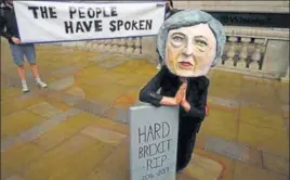  ?? REUTERS ?? A protester wears a Theresa May mask in London on Friday. For the voters, the election was about Britain’s future in the European Union, about its embrace of the free market, about pensions and housing, health and affordable education.