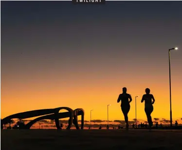  ?? DAVID RITCHIE African News Agency (ANA) ?? A COUPLE of joggers enjoy a picturesqu­e sunset on the Sea Point Promenade. It is one of Cape Town’s most scenic walkways and recreation­al spaces, situated between the Pavilion swimming pool and Granger Bay, and has undergone major repairs in the past five years.