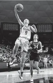  ?? Jessica Hill / Associated Press ?? Paige Bueckers scores against Notre Dame on Sunday before being injured in the final seconds.