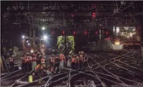  ?? CHUCK GOMEZ — AMTRAK (VIA AP) ?? In this April 5 photo provided by Amtrak, workers repair rails inside New York’s Penn Station. Accelerate­d repair work in the wake of recent breakdowns at New York’s Penn Station will begin in May and cause delays this summer for rail travelers who...