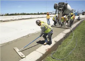  ?? Rich Pedroncell­i / Associated Press ?? Crews repave a street in Roseville (Placer County), work partially funded by a gas tax hike passed in 2017 that would be repealed if Propositio­n 6 is approved.