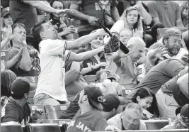  ?? ASSOCIATED PRESS ?? A fan makes a catch after Toronto Blue Jays’ Steve Pearce lost his bat during the first inning against the Tampa Bay Rays in Toronto on Monday.