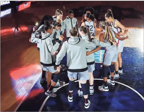  ?? Carmen Mandato / Getty Images ?? The UConn Huskies huddle up during intros prior to the first quarter against the Arizona Wildcats in the Final Four semifinal game of the 2021 Women’s NCAA Tournament at the Alamodome on April 2 in San Antonio, Texas.