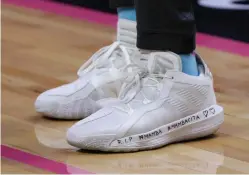  ?? Lynne Sladky/Associated Press ?? ■ Miami Heat guard Goran Dragic wears inscribed shoes as a tribute to NBA basketball player Kobe Bryant and his daughter Gianna on Monday before a game against the Orlando Magic in Miami. Bryant and Gianna were among those who died in a helicopter crash Sunday in California.