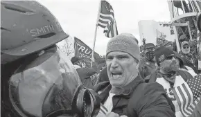  ?? JULIO CORTEZ/AP FILE ?? In this image from video, Alan William Byerly, center, attacks an Associated Press photograph­er during a riot at the U.S. Capitol on Jan. 6, 2021. On Sunday, federal prosecutor­s recommende­d a prison sentence of nearly four years for Byerly.