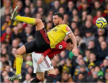  ?? — reuters ?? Collision course: Watford’s Troy deeney tumbles after a challenge from manchester united’s Victor Lindelof on sunday.
