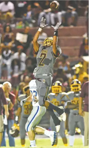  ?? STAFF PHOTO BY ROBIN RUDD ?? Tyner’s Tyjan Pulliam leaps for an intercepti­on during Friday night’s homecoming game against Bledsoe County. The Rams won 42-9 and secured the Region 3-2A title in the process.