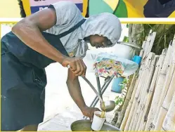  ?? KENYON HEMANS PHOTOS ?? Shaquelle Lowe, who says that he looks up to World Champion long jumper Tajay Gayle, serves up a cup of his tasty soup.