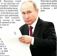  ?? — AFP photo ?? Putin votes at a polling station during Russia’s presidenti­al election in Moscow.