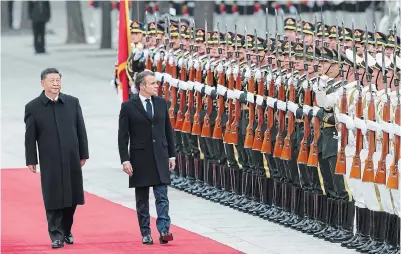  ?? LINTAO ZHANG GETTY IMAGES ?? Chinese President Xi Jinping, left, accompanie­s French President Emmanuel Macron to view an honour guard in Beijing.