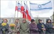  ?? Associated Press ?? People holding daffodils attend celebratio­ns marking the 74th anniversar­y of the 1943 Warsaw Ghetto Uprising in Warsaw, Poland, on Wednesday.