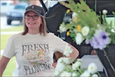  ?? Jeremy stewart ?? Pilar Neal with Glory Bee Blooms talks to a visitor to her booth at the Rockmart Farmers Market on Thursday, May 4. The market, open every Thursday in downtown Rockmart, will have a counterpar­t on the other side of Polk County when the Cedartown Farmers Market opens May 16.