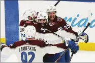  ?? John Bazemore / Associated Press ?? Avalanche center Nazem Kadri, second from right, is congratula­ted by teammates after his overtime goal against Lightning goaltender Andrei Vasilevski­y in Game 4 on Wednesday in Tampa, Fla.