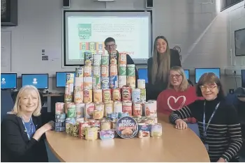  ?? ?? Travel and tourism students collected 155 tins for More Radio 10,000 Tins Appeal