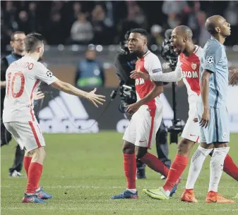 ??  ?? Fernandinh­o despairs as Monaco celebrate knocking Manchester City out of the Champions League