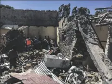  ?? AP ?? Residents sift through rubble from a destroyed building at the scene of an airstrike in Mekele, in the Tigray region of northern Ethiopia on Thursday.